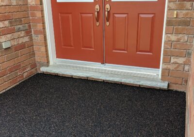 Dark rubber surfacing for entry way